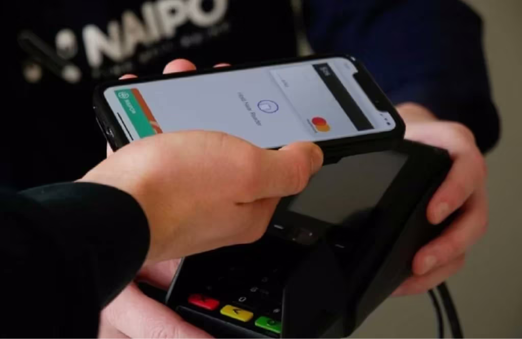 man paying item using his phone tap