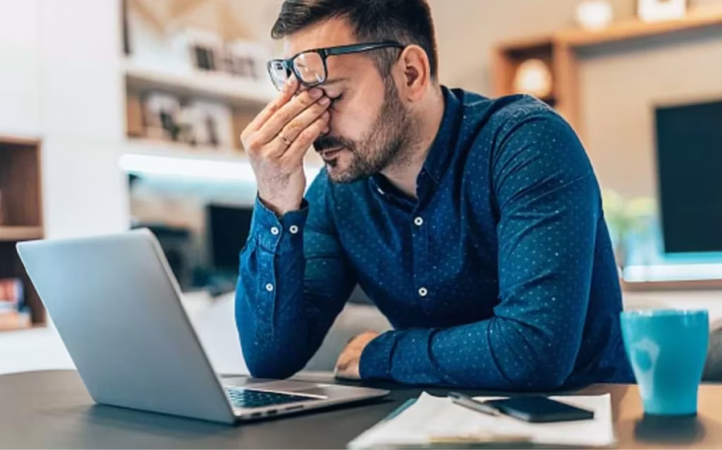 Man looking stressed at his computer