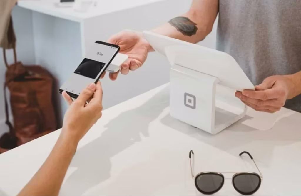 man paying item with his phone scan